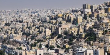 Aerial view of Amman, Jordan showcasing dense urban architecture and vibrant city life.